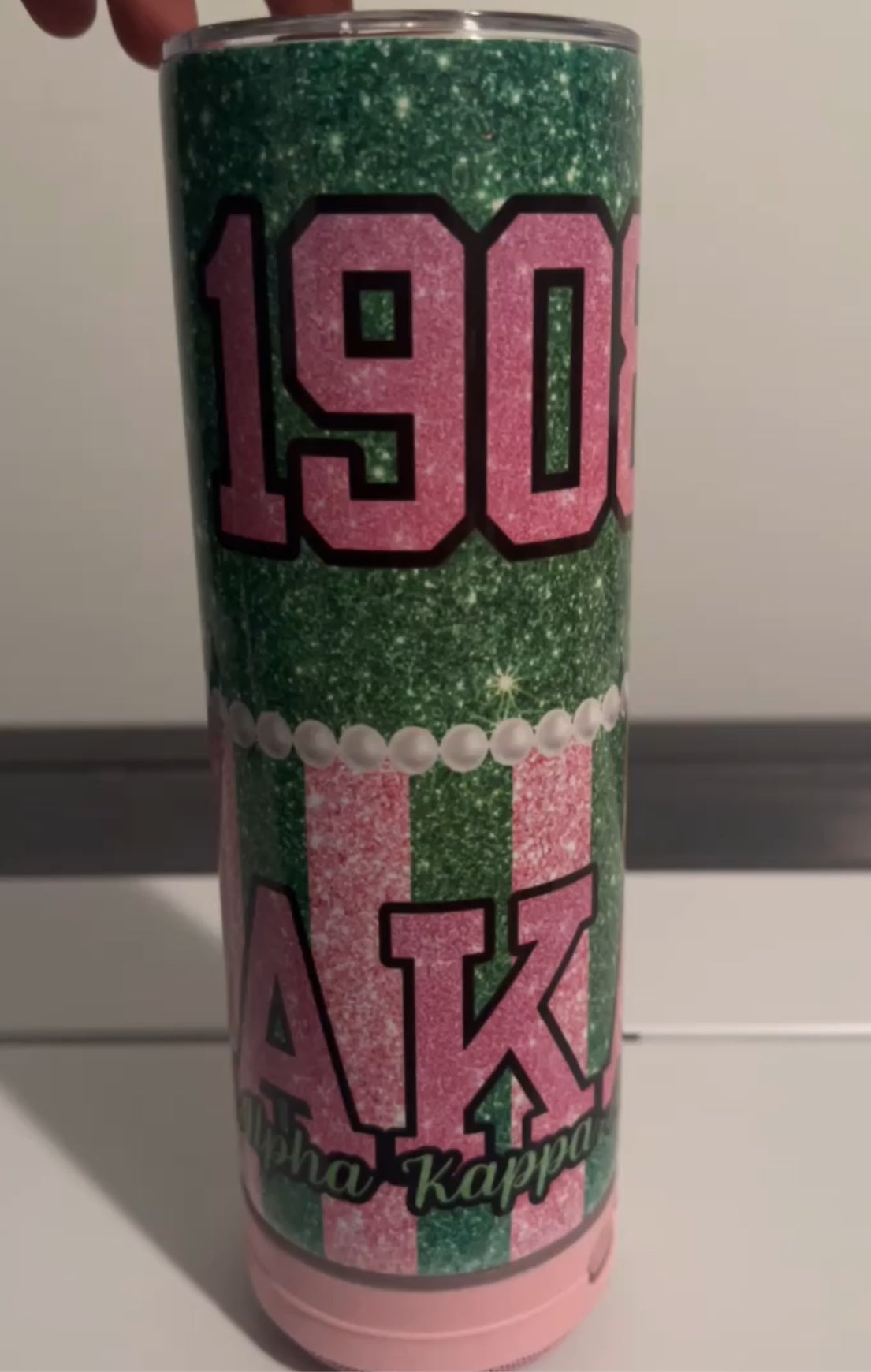 “20oz AKA Bluetooth Tumbler – Elegant tumbler with Alpha Kappa Alpha Sorority design and built-in Bluetooth speaker, perfect for on-the-go music and showing sorority pride. Available now at craftybrowngirl.com.”