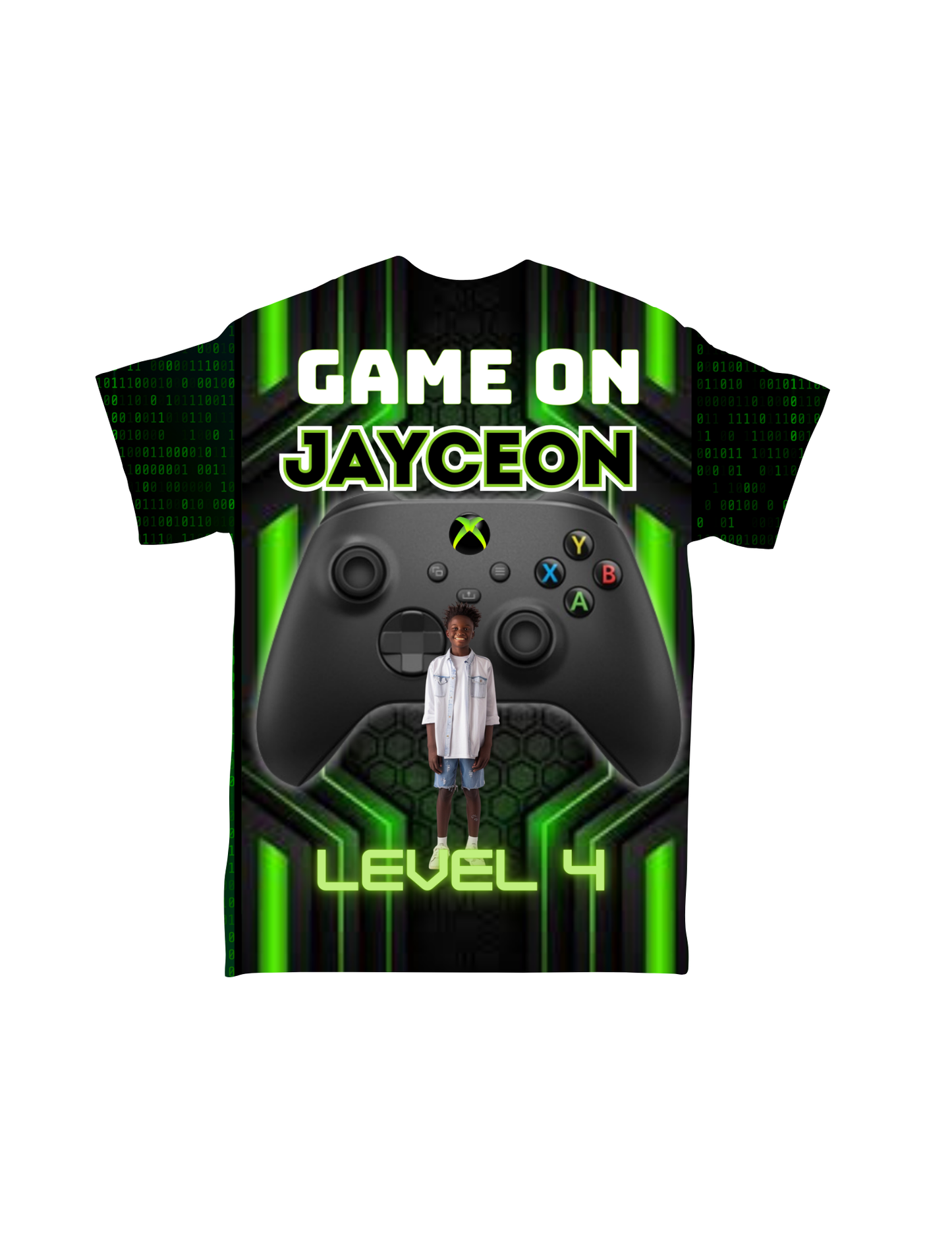 The Cartoon Character All-Over T-Shirt by Crafty Brown Girl features the text "GAME ON JAYCEON" at the top with a prominent Xbox controller graphic in the center. Below the controller, a photo of a standing child is displayed along with the text "LEVEL 4" at the bottom. The background boasts a green and black digital design, making it ideal for custom-designed t-shirt enthusiasts.