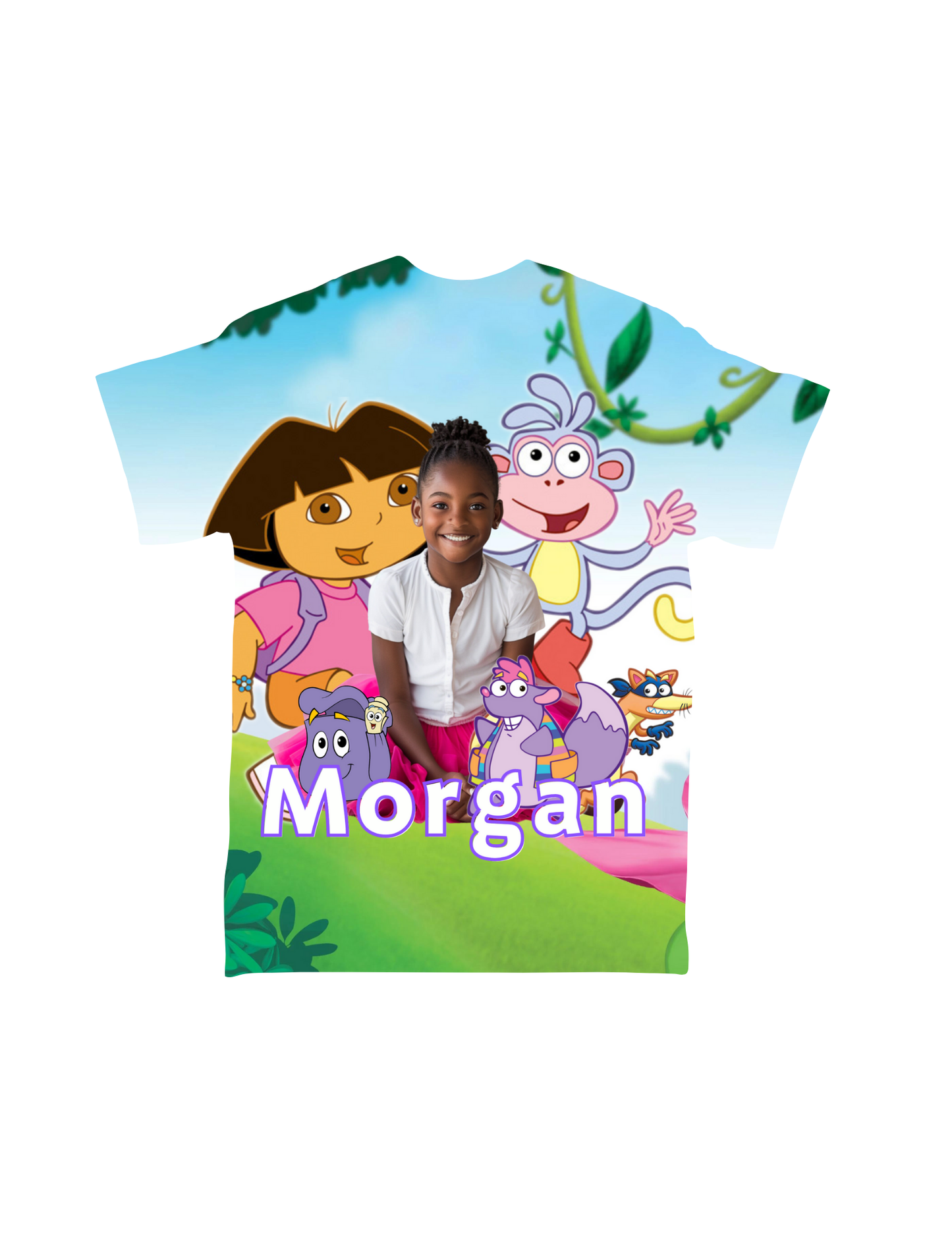 A vibrant, custom-designed "Cartoon Character All-Over T-Shirt" from Crafty Brown Girl, featuring a child smiling in front of an animated background with characters from "Dora the Explorer," including Dora, Boots, and Swiper. The name "Morgan" is prominently displayed in large purple letters at the bottom.