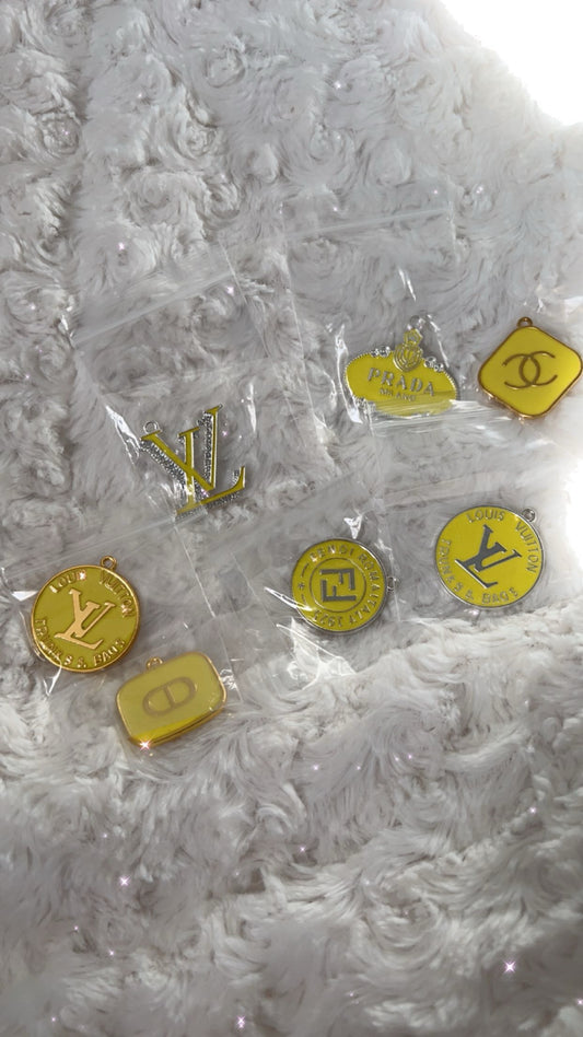 “Bright yellow designer charms in various unique shapes, perfect for DIY projects, custom jewelry, and personalized accessories. Add a pop of color to your creations with these high-quality, vibrant yellow charms. 